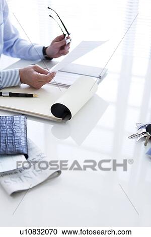 Stock Image - Businessman with paperwork. Fotosearch
