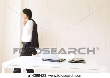 Stock Image - Businessman with suit jacket over shoulder. Fotosearch