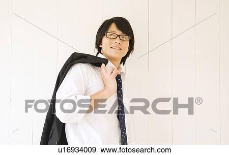 Businessman with suit jacket over shoulder View Large Photo Image Stock Photo - Businessman with suit jacket over shoulder. Fotosearch