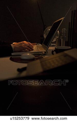 Stock Photo - Businessman working at desk in office. Fotosearch