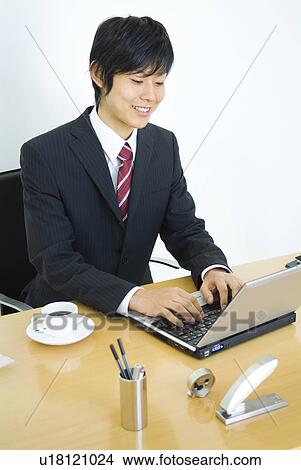 Picture - Businessman working at his desk. Fotosearch