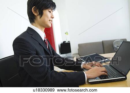 Stock Photo - Businessman working at his desk. Fotosearch