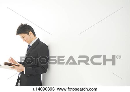 Businessman writing in personal organizer View Large Photo Image Stock Image - Businessman writing in personal organizer. Fotosearch