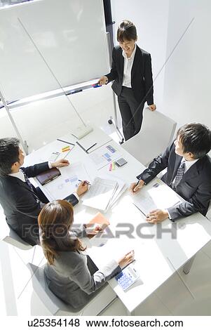 Stock Photo - Businessmen and a businesswoman in a conference. Fotosearch