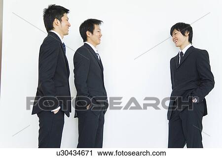 Businessmen talking and smiling View Large Photo Image Stock Image - Businessmen talking and smiling. Fotosearch