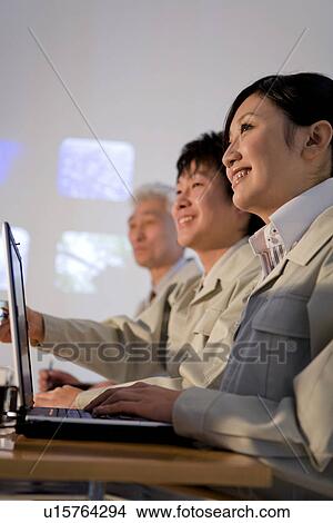 Picture - Businesspeople in presentation. Fotosearch