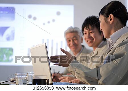 Stock Image - Businesspeople in presentation. Fotosearch