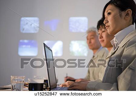 Businesspeople in presentation View Large Photo Image Stock Photo - Businesspeople in presentation. Fotosearch