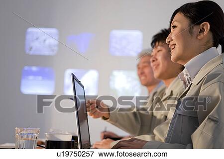 Stock Photo - Businesspeople in presentation. Fotosearch