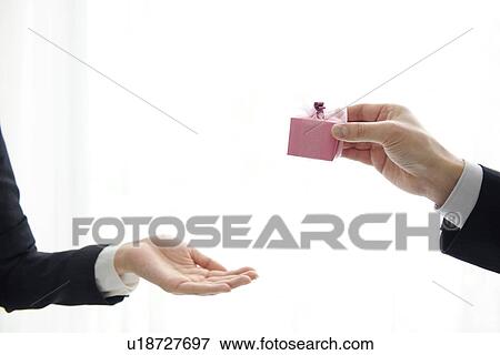 Businessperson giving a gift View Large Photo Image Stock Photo - Businessperson giving a gift. Fotosearch