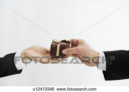 Stock Photograph - Businessperson giving a gift. Fotosearch