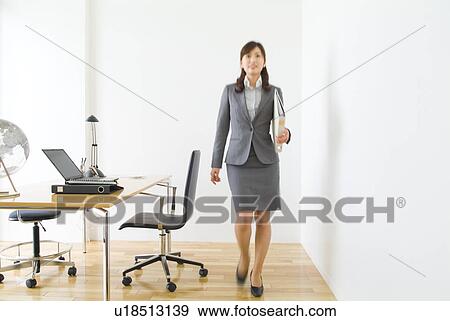 Stock Photo - Businesswoman carrying files. Fotosearch