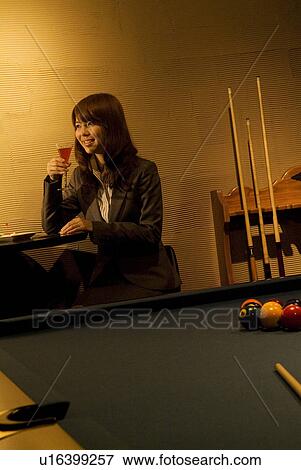 Businesswoman drinking a cocktail at a bar View Large Photo Image Stock Photo - Businesswoman drinking a cocktail at a bar. Fotosearch