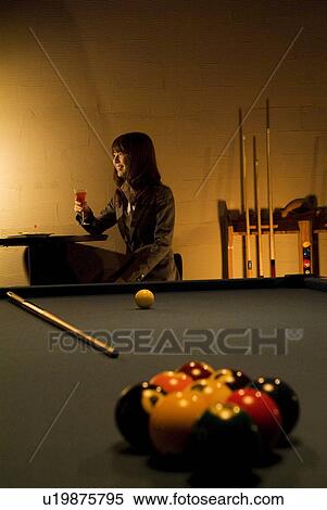 Stock Photography - Businesswoman drinking a cocktail at a bar. Fotosearch