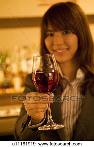 Businesswoman drinking wine at a bar View Large Photo Image Stock Photo - Businesswoman drinking wine at a bar. Fotosearch
