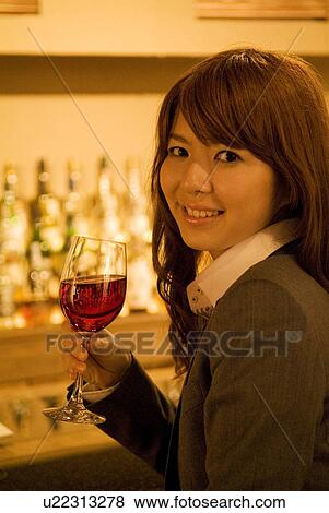 Businesswoman drinking wine at a bar View Large Photo Image Stock Photo - Businesswoman drinking wine at a bar. Fotosearch