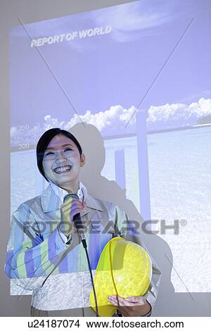 Businesswoman giving presentation with projector screen View Large Photo Image Picture - Businesswoman giving presentation with projector screen. Fotosearch