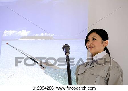 Businesswoman giving presentation with projector screen View Large Photo Image Stock Photograph - Businesswoman giving presentation with projector screen. Fotosearch