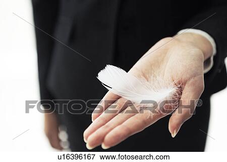 Stock Photo - Businesswoman holding a feather. Fotosearch