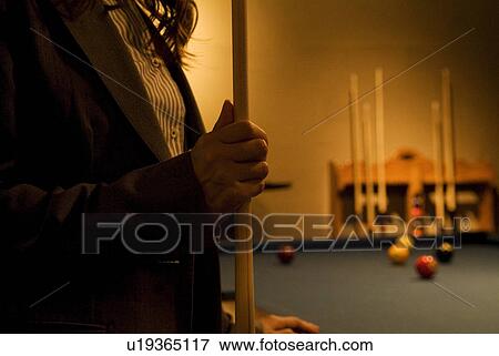Businesswoman holding a pool cue View Large Photo Image Stock Photo - Businesswoman holding a pool cue. Fotosearch