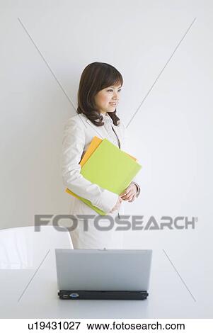 Businesswoman holding files View Large Photo Image Stock Photo - Businesswoman holding files. Fotosearch