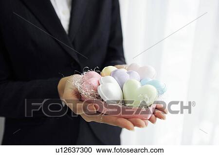 Businesswoman holding heart shaped soaps View Large Photo Image Stock Image - Businesswoman holding heart shaped soaps. Fotosearch