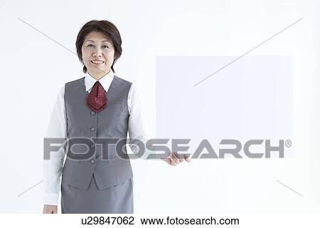 Businesswoman holding up blank sign View Large Photo Image Stock Image - Businesswoman holding up blank sign. Fotosearch