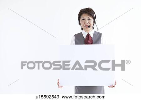 Businesswoman holding up blank sign View Large Photo Image Stock Photo - Businesswoman holding up blank sign. Fotosearch