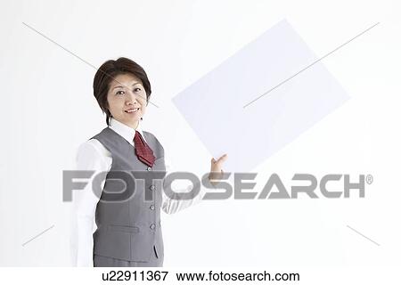 Businesswoman holding up blank sign View Large Photo Image Stock Photo - Businesswoman holding up blank sign. Fotosearch