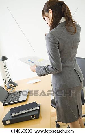 Businesswoman looking at documents View Large Photo Image Stock Image - Businesswoman looking at documents. Fotosearch