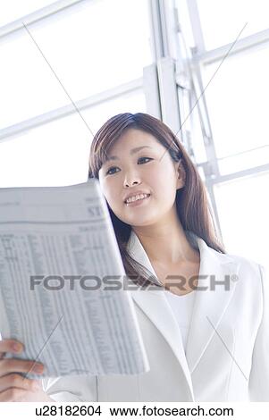 Businesswoman reading newspaper View Large Photo Image Picture - Businesswoman reading newspaper. Fotosearch