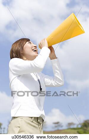 Stock Photograph - Businesswoman shouting into megaphone. Fotosearch