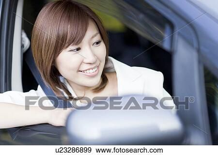 Stock Photo - Businesswoman sitting in car. Fotosearch