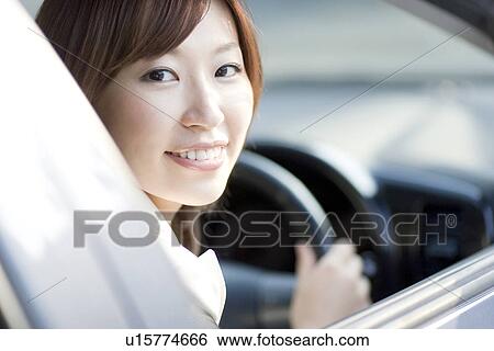 Stock Photograph - Businesswoman sitting in car. Fotosearch