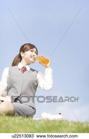 Businesswoman sitting outside drinking juice View Large Photo Image Stock Image - Businesswoman sitting outside drinking juice. Fotosearch