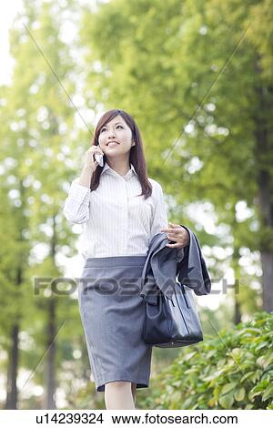 Picture - Businesswoman talking on mobile phone. Fotosearch