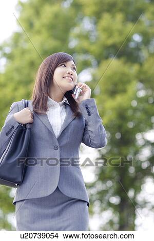 Businesswoman talking on mobile phone View Large Photo Image Picture - Businesswoman talking on mobile phone. Fotosearch