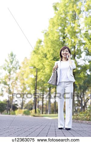 Businesswoman talking on mobile phone View Large Photo Image Stock Photography - Businesswoman talking on mobile phone. Fotosearch