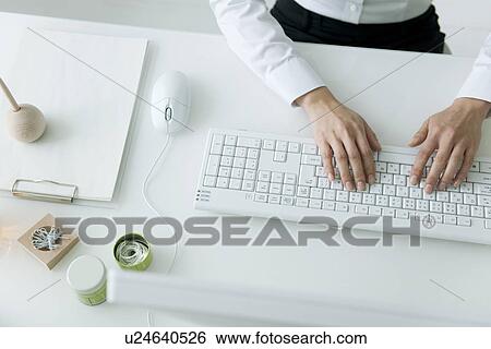 Stock Photograph - Businesswoman typing on computer keyboard. Fotosearch