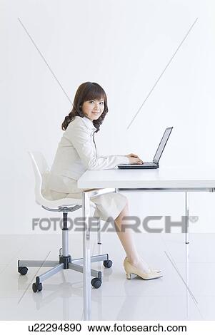 Businesswoman typing on laptop View Large Photo Image Stock Image - Businesswoman typing on laptop. Fotosearch