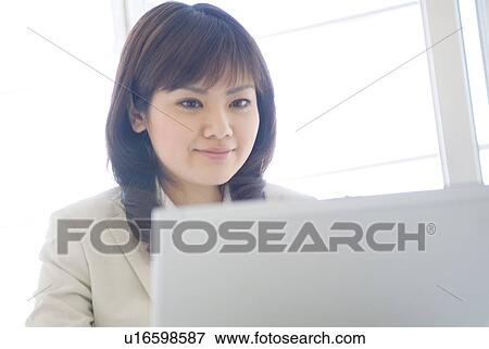 Businesswoman typing on laptop View Large Photo Image Stock Photo - Businesswoman typing on laptop. Fotosearch