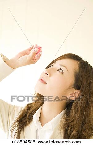 Stock Photo - Businesswoman using eye drops. Fotosearch