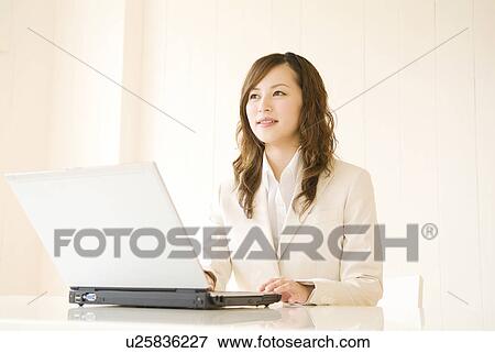 Businesswoman using laptop computer View Large Photo Image Stock Photo - Businesswoman using laptop computer. Fotosearch