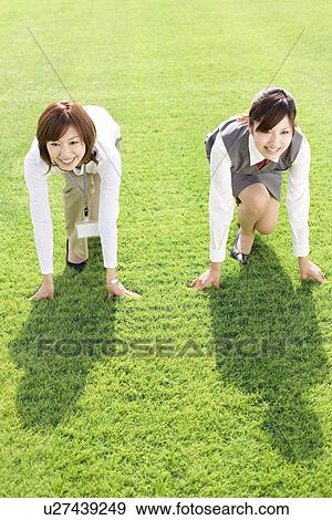 Businesswomen about to run race View Large Photo Image Stock Photo - Businesswomen about to run race. Fotosearch