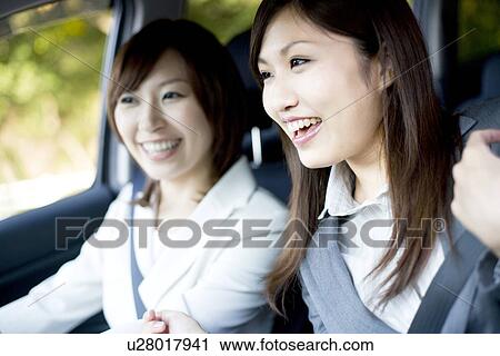 Stock Image - Businesswomen in car. Fotosearch
