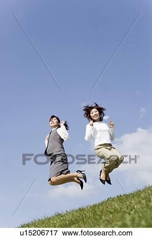 Businesswomen jumping into air View Large Photo Image Stock Photo - Businesswomen jumping into air. Fotosearch
