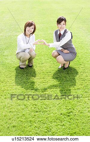 Businesswomen making heart shape with hands View Large Photo Image Picture - Businesswomen making heart shape with hands. Fotosearch