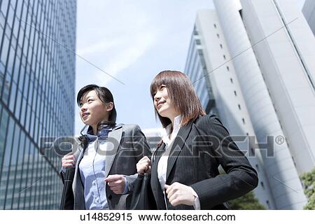 Stock Photography - Businesswomen running in street. Fotosearch