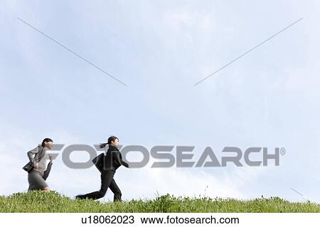 Businesswomen running on grass View Large Photo Image Stock Image - Businesswomen running on grass. Fotosearch