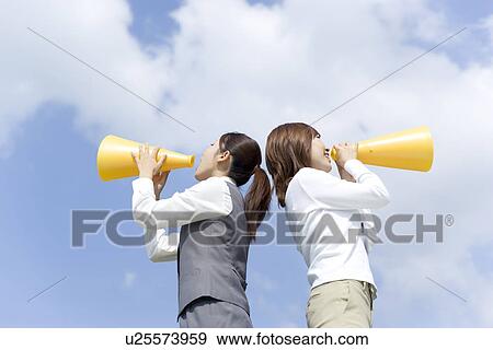 Stock Photo - Businesswomen shouting into megaphone. Fotosearch